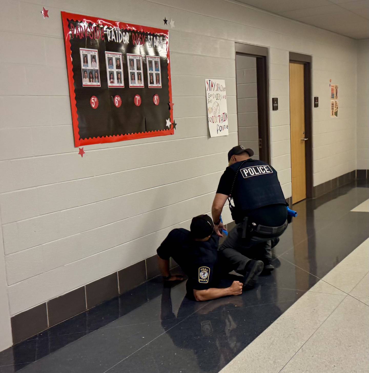 Patrol Officer Ben Bentley stops to render aid to the SRO (Patrol Officer Winfert) during an active shooter simulation.