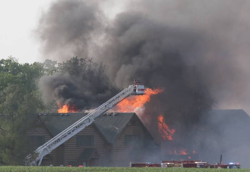 Ottawa firefighters use their aerial fire truck to extinguish flames at Grand Bear Resort on Monday, May 30, 2022.