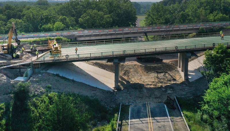 An aerial view of crews working on the Interstate 180 bridge crossing over Tiskilwa Bottom Road on Tuesday, July 8, 2025 near Tiskilwa. The Illinois Department of Transportation continues to work on the 180 bridges over Bureau Creek and Tiskilwa Bottom Road.  The I-180 work zone is a mile south of the Route 26 interchange. Both the south and northbound bridges are being replaced. Girders have been installed on the bridge. Tiskilwa Bottom Road remains closed under I-180 during the project and traffic should follow the posted detour signs. The 24.2 million project is scheduled to be completed by the end of 2026.