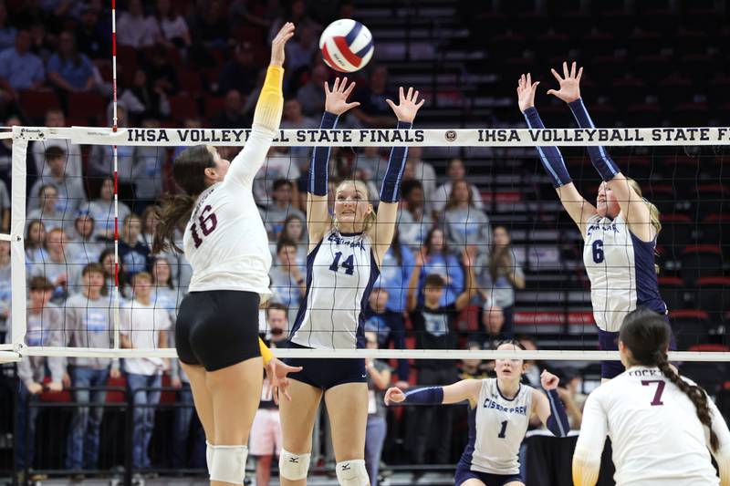 Cissna Park's Annika Stadeli, center, and Marina Day jump to block a hit during the Timberwolves' victory in two sets, 25-11, 25-14, over Stockton in the IHSA Class 1A State championship on Saturday, Nov. 15, 2025.
