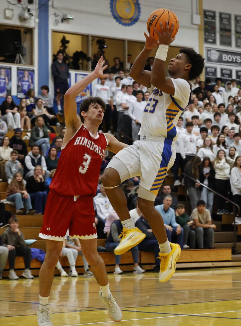Lyons Township's Blake Ragsdale (23) puts up a shot during a varsity basketball game between Hinsdale Central and Lyons Township high schools on Friday, Dec. 12, 2025 in La Grange.