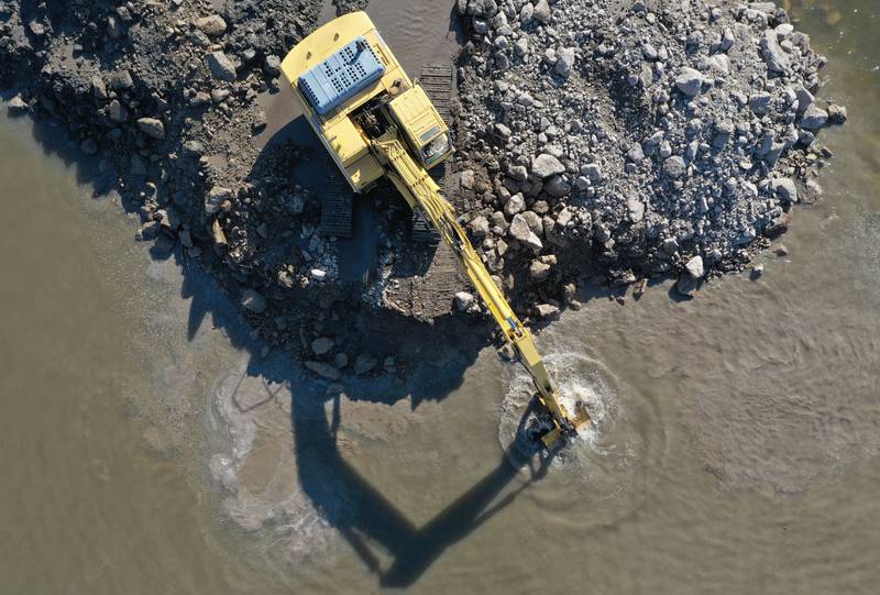 An excavator dredges the harbor at Barto Landing on Wednesday, March 26, 2025 in Spring Valley.