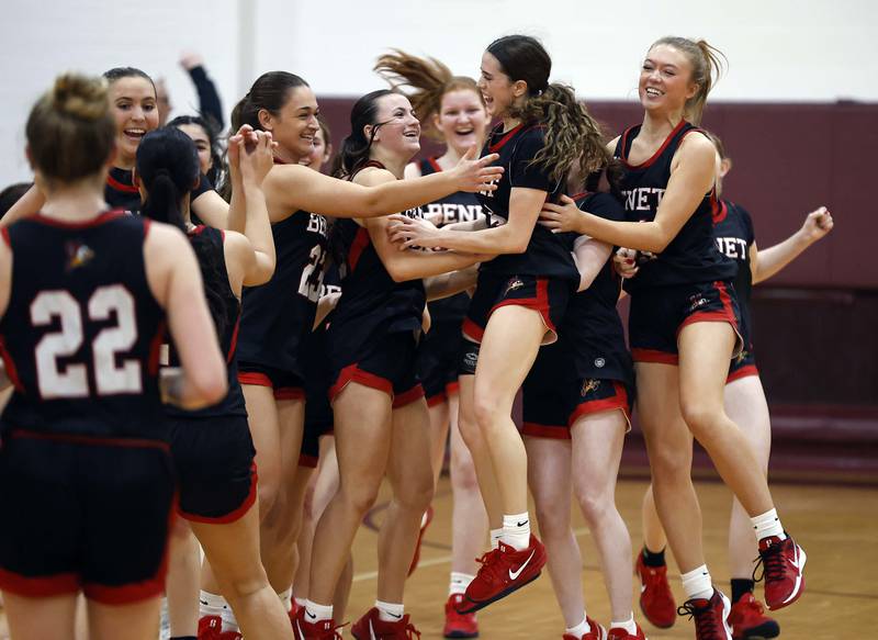 Benet Academy's Ava Mersinger (4) is mobbed by her teammates after the Redwings defeated Fremd during the Montini girls basketball Christmas tournament Saturday, Dec. 28, 2024 in Lombard.