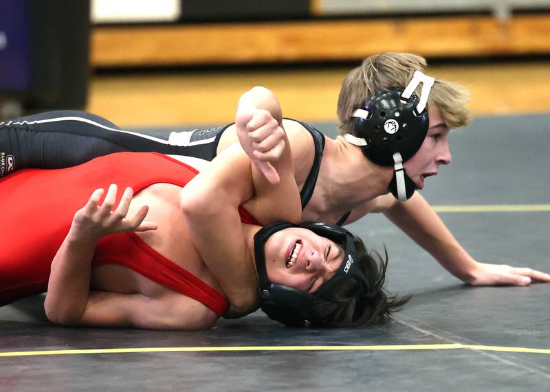 Sycamore’s Michael Olson tries to turn Ottawa’s Giovanni Hernandez during their 113 pound match Thursday, Dec. 14, 2023, at Sycamore High School.
