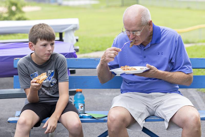James Adell and Norm Adell enjoy some food Friday, July 25, 2025, during a family fun day at the end of the Emma Hubbs Tennis Classic.