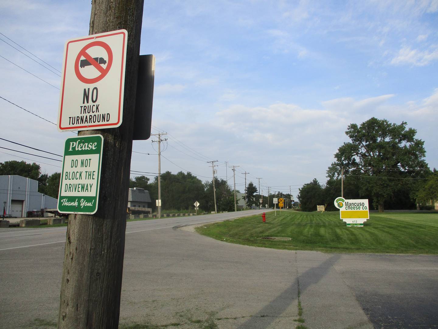 Signs posted along an industrial stretch of Mills Road in Joliet give notice to truckers. July 30, 2024