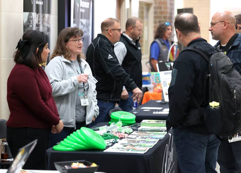 Vistors receive information from one of the booths Wednesday, Oct. 22, 2025, during Trades Exploration Day at DeKalb High School. The event hosted several companies and organizations that were offering information on opportunities in the trades.