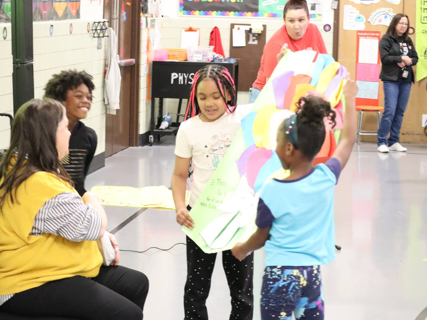 Jefferson Elementary School Principal Melanie Bickley accepts gifts from Jefferson students on National Principal's Day. She also received another surprise during the assembly on May 1, 2025: She was named Administrator of the Year by the Illinois Association for Health, Physical Education, Recreation and Dance.