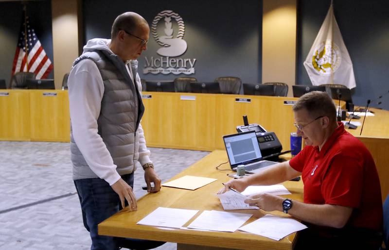 McHenry Mayor Wayne Jett files his paperwork Tuesday, Nov. 12, 2024, to run for another term as mayor of McHenry with McHenry Deputy Clerk Monte Johnson during first day of filing for the consolidated election on April 1, 2025.