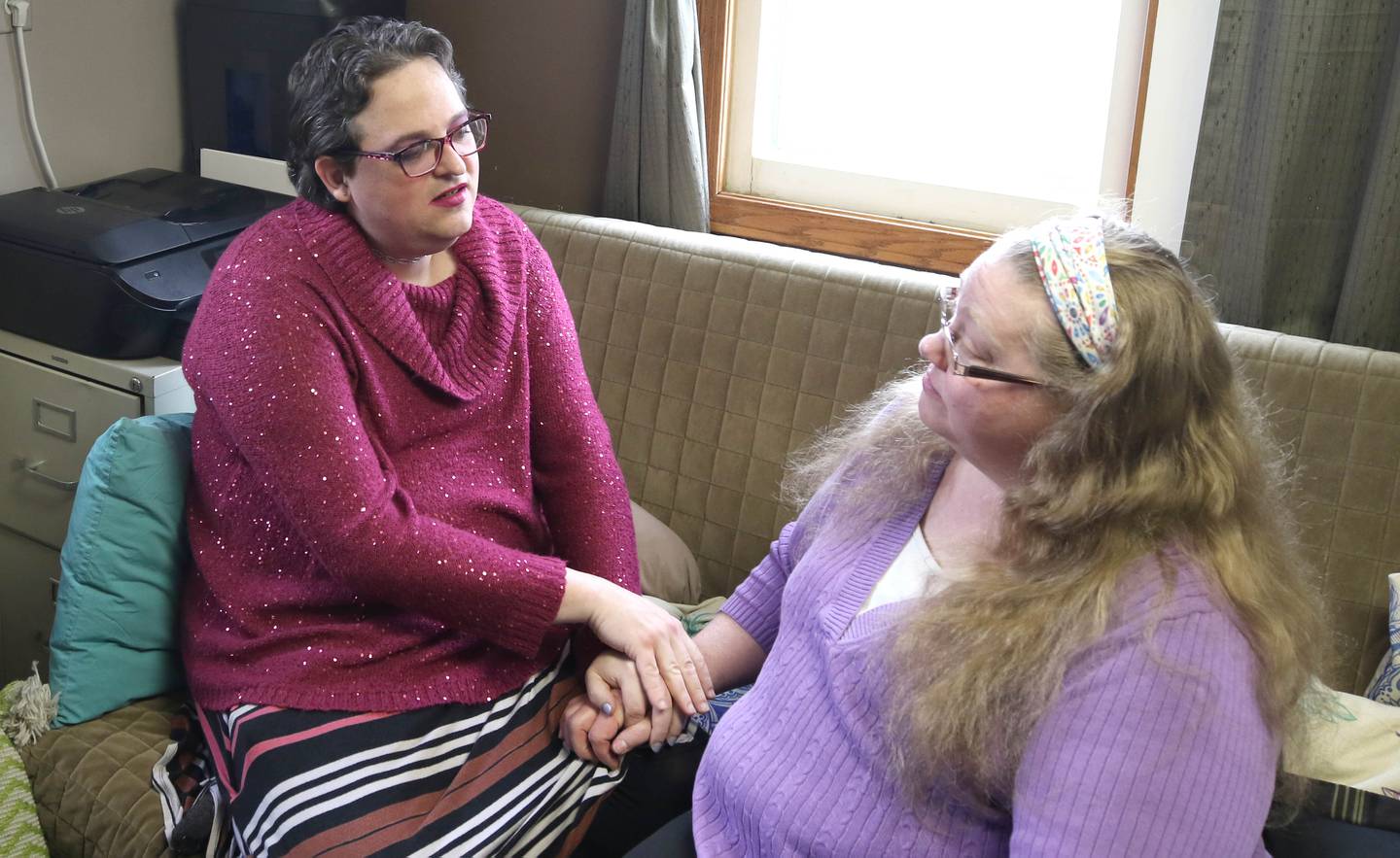 Elizabeth Fern Jensen (left) talks to fiancé Jamie Jensen Tuesday, Dec. 13, 2022, in their DeKalb home.