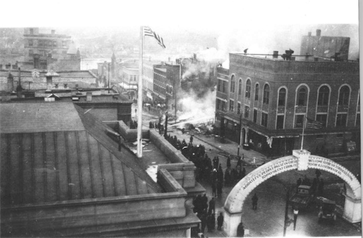 This 1920 photo of South Galena Avenue shows the original wording on the 1919 arch, Lee County Genealogical Society President Pat Gorman said. The photo was intended to depict the burning of the Dixon Theater farther down the block.