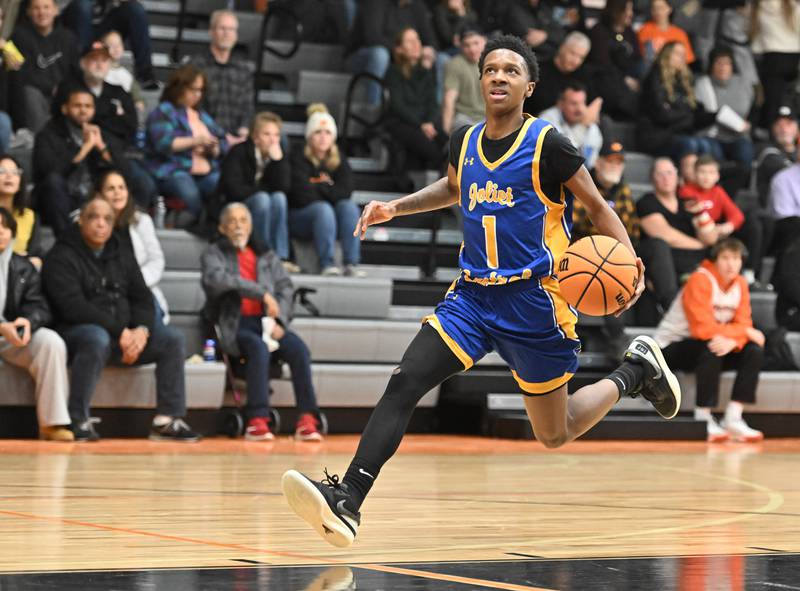 Joliet Central's Bernal Fox (1) drives to basket on a fast break during a conference game against Minooka on Friday, Jan. 10, 2025, at Minooka.
