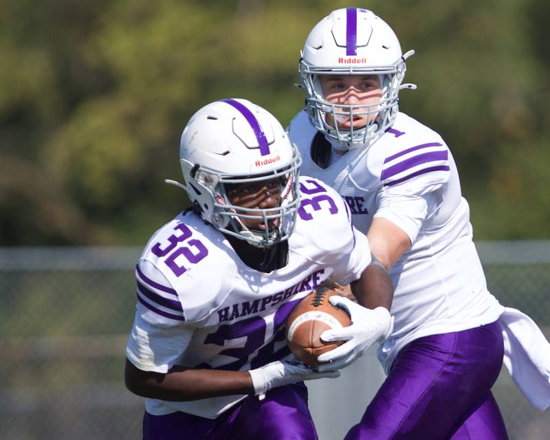Hampshire's Ryan Prowicz hands the ball off to Tymere Marshall on Saturday Oct. 5,2024 in Cary.