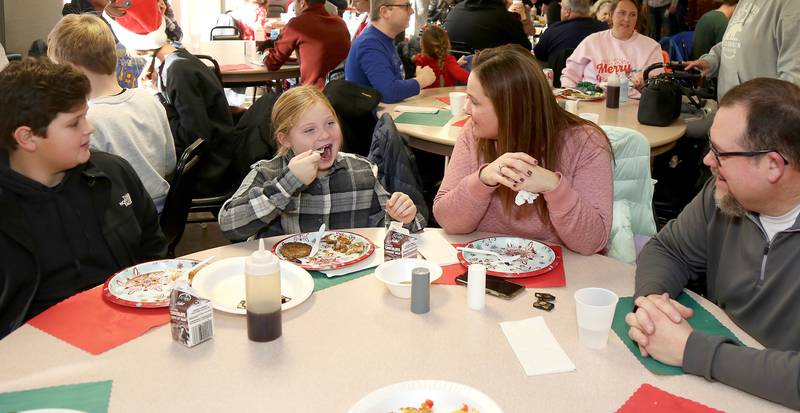 The Olson family of DeKalb eats breakfast at Breakfast with Santa in Elburn on Sunday, Dec. 4, 2022.