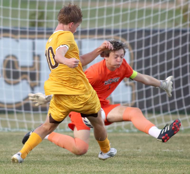 Jacobs’  Jackson Foley takes a shot as Prairie Ridge goalkeeper Christopher Zinevich makes a save in varsity soccer at Jacobs High School in Algonquin on Thursday, Sept. 18, 2025.