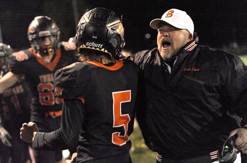 Sandwich Head Coach Kris Cassie celebrates with Cole Leeper (5), after he ran back a kickoff for a touchdown against Ridgewood during a varsity football game at Sandwich High School on Friday, Oct. 27, 2023.