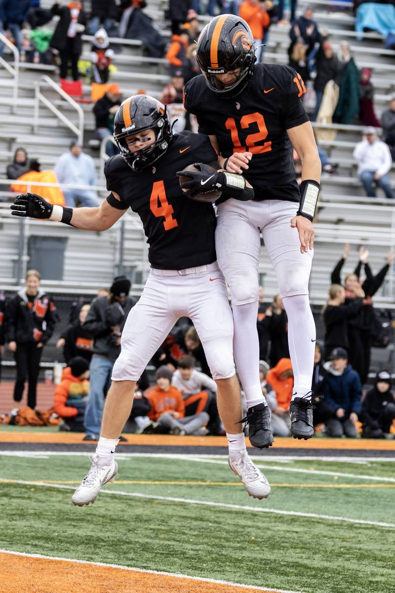 Lincoln-Way West's Ethan Swanson and Grant Tustin celebrate after Swanson scored a touchdown during a 7A varsity football playoff game against Kenwood at Lincoln-Way West on Nov. 8, 2025.