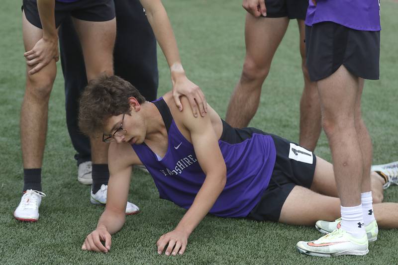 Hampshire’s Mitchell Dalby is surrounded by teammates after running the last leg of the 4 x 800 meter relay during the IHSA Class 3A Huntley Boys Track and Field Sectional Wednesday, May 18, 2022, at Huntley High School.
