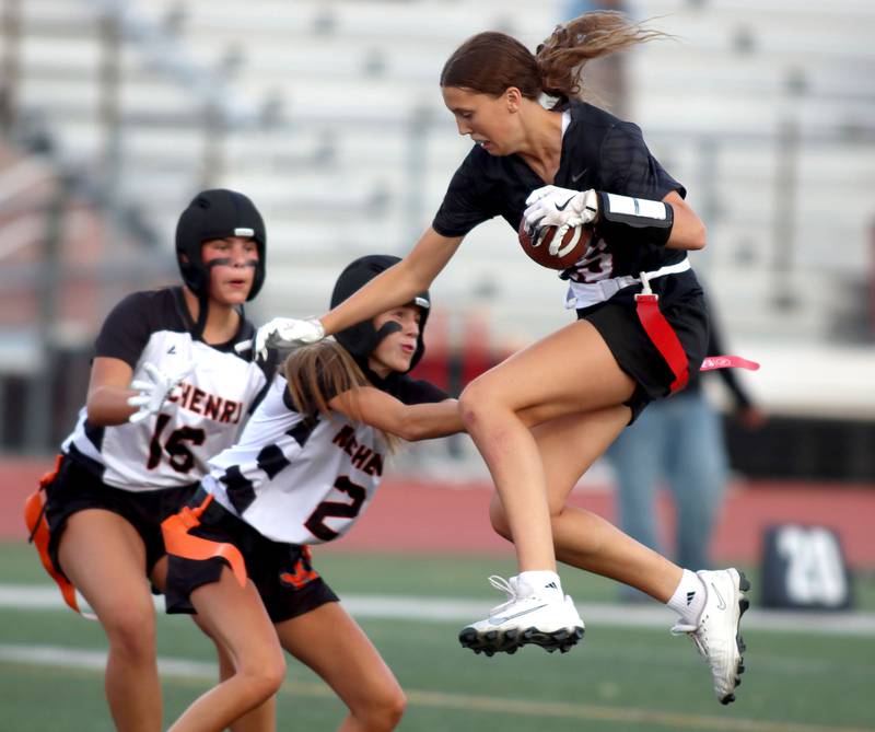 Huntley’s Evelyn Freundt leaps into the end zone with a touchdown against McHenry in varsity flag football at Huntley High School in Huntley on Tuesday, Sept. 9, 2025.