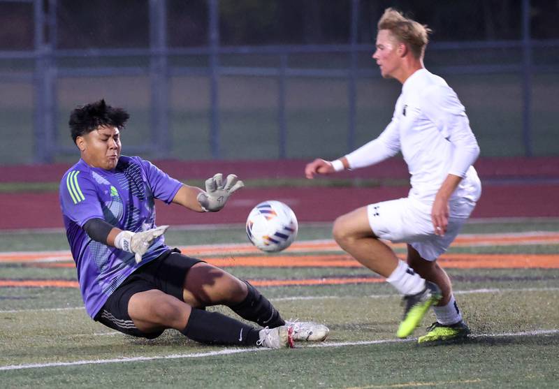 DeKalb goalie Diego Reyos tries to stop Sycamore's Aiden Sears on a breakaway during their game Thursday, Oct. 10, 2024, at DeKalb High School.