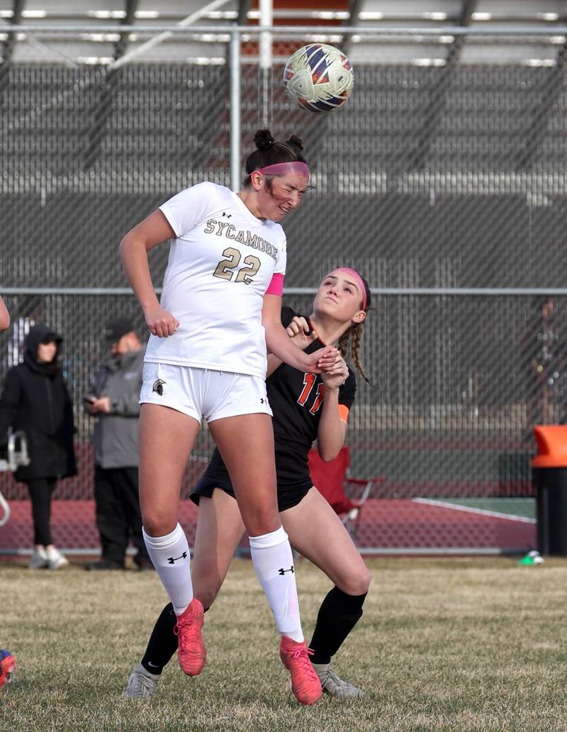 Sycamore's Hailey Clawson (left) goes up for a header over Plainfield East's Caroline Dinnon during their game Tuesday, March 25, 2025, in the Barb Fest tournament at DeKalb High School.