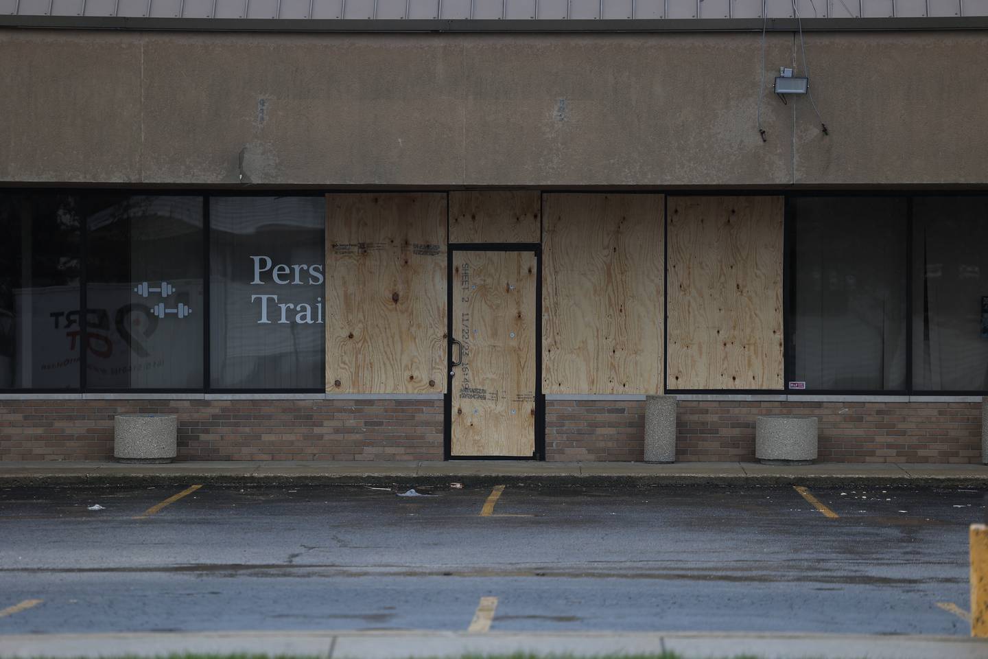 Windows are boarded up after being shot out across the street from Merichka’s on Wednesday, April 3, 2024 in Joliet.