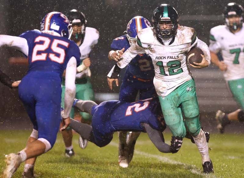 Rock Falls' Austin Castaneda gets by a diving Genoa-Kingston's Xander Gleissner during their game Friday, Oct. 13, 2023, at Genoa-Kingston High School.