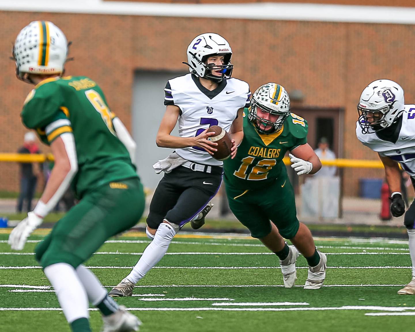 Dixon's Cullen Shaner (2) is pursued by Coal City's Emmett Easton (12) during Class 4A quarterfinal football game between Dixon at Coal City on Saturday, Nov 16, 2024  in Coal City.