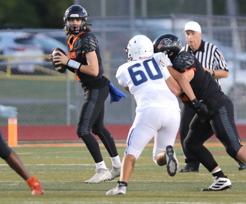 DeKalb's Cole Latimer looks for a receiver as he is pressured by Plainfield South's Nathan Ibarra during their game Friday, Sept. 1, 2023, at DeKalb High School.