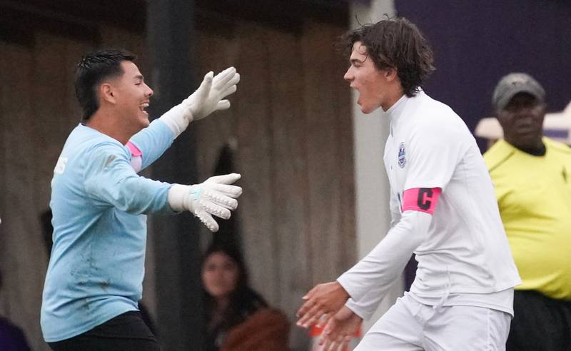 Woodstock's Diego Landeros (left) greets Woodstock's Lucas Rubio (right) after Rubio scores a goal against Plano during a soccer match at Plano High School on Monday, Sept. 11, 2023.