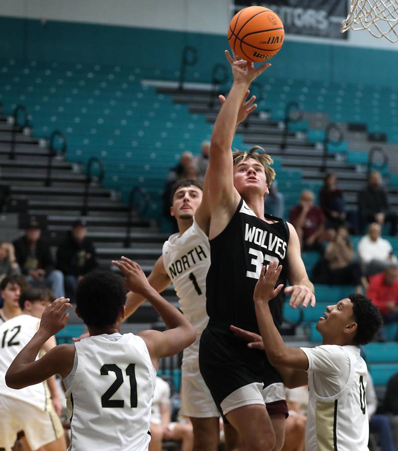 Prairie Ridge's Maddon McKim drives to the basket against the Grayslake North defense during the 2025 Hoops for Healing tournament basketball game on Wednesday, Nov. 26, 2025, at Woodstock North High School.