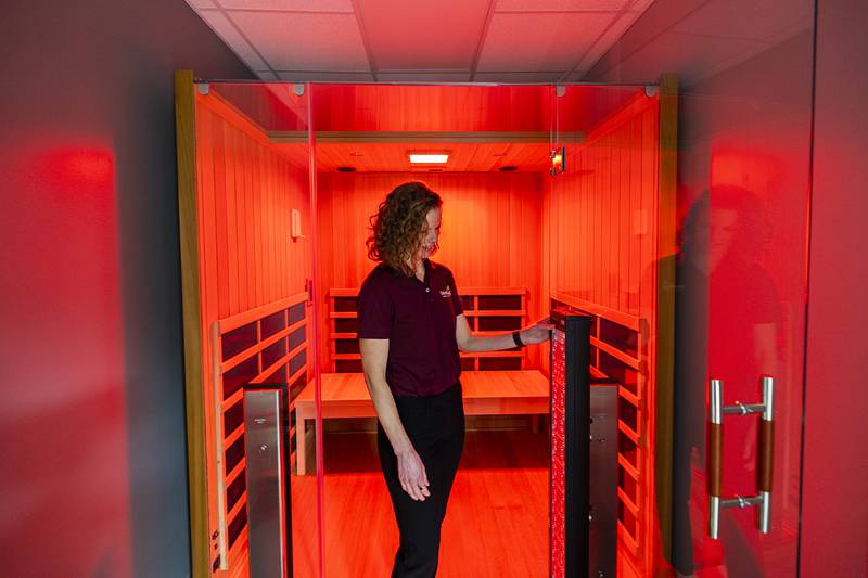 Breanne Hunter, Sterling Park District's marketing director, describes the infrared sauna on Tuesday, Jan. 31, 2023. It uses light to create heat, which is more comfortable for the user. This ADA approved sauna also offers red light and salt therapy.