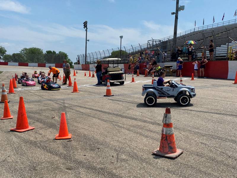 The kids trail behind the pace car Monday afternoon at the Grundy County Fair.