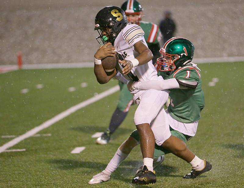 Sycamore's Tyler Curtis (4) runs the ball down the field as L-P's Caleb Burrell (1) brings him down on Friday, Oct. 14, 2022 at Howard Fellows Stadium in Peru.