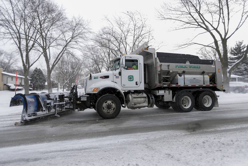 A snowplow clears a residential street in Downers Grove on Monday, Jan. 24, 2022.