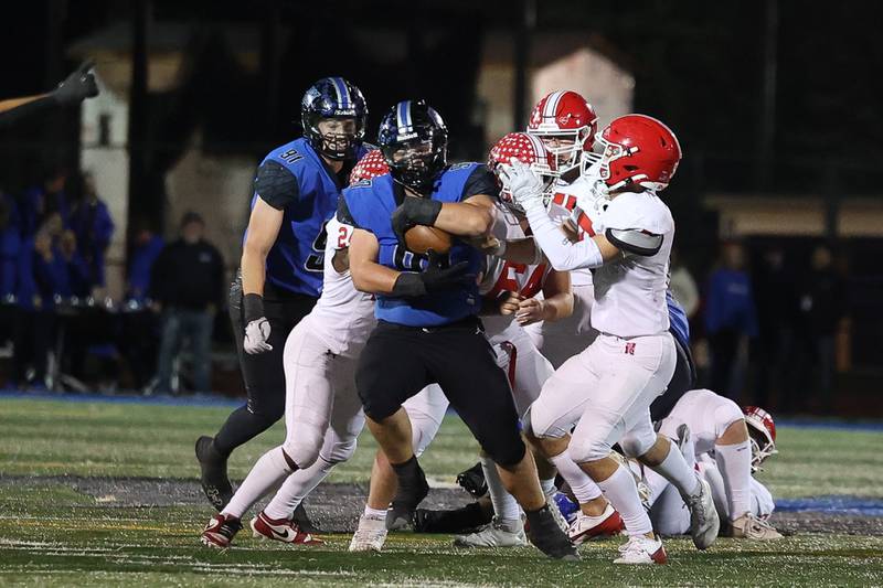 Lincoln-Way East’s Gage LaDere pulls in an interception which he returned for a touchdown against Naperville Central on Friday, Oct. 25, 2024 in Frankfort.