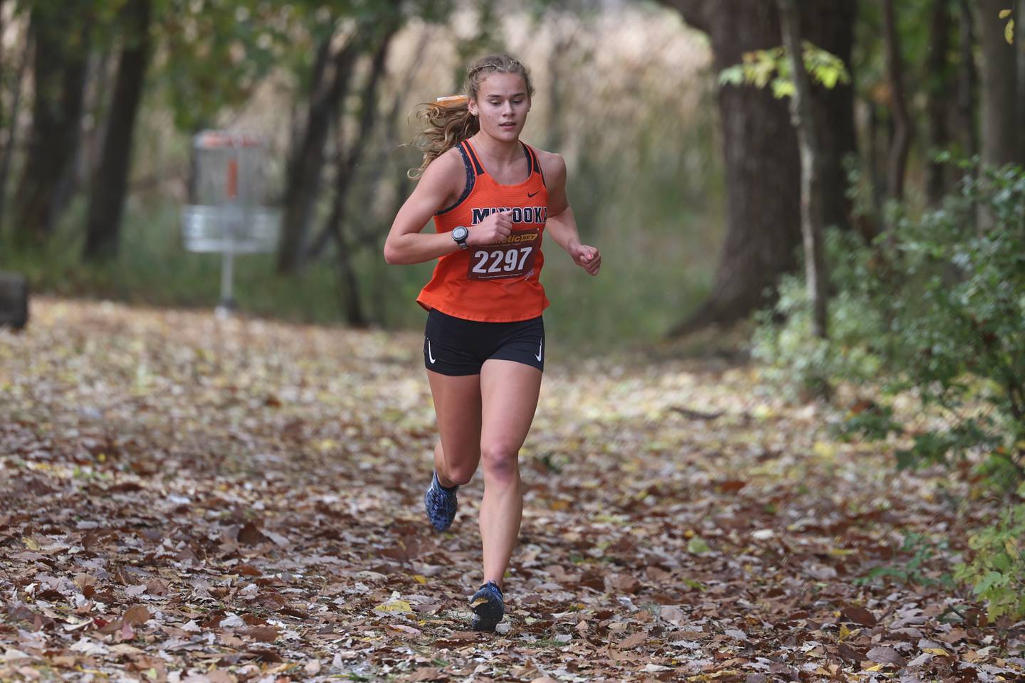 Minooka’s Gabriella McCollom rounds the halfway mark with a comfortable second place lead in the Girls Cross Country Southwest Prairie Conference Championship at Channahon Community Park on Friday.