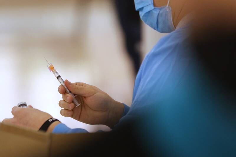 A worker prepares a Moderna COVID-19 vaccination syringe Tuesday, March 2, 2021, during a McHenry County Department of Health clinic at 1900 N. Richmond Road, the former site of a Kmart in McHenry. Vaccinations are made by appointment only.