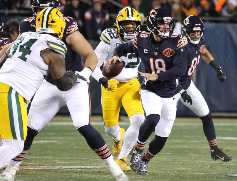 Chicago Bears quarterback Caleb Williams avoids the Green Bay Packer pass rush Saturday, December 20, 2025, during their game at Soldier Field in Chicago.