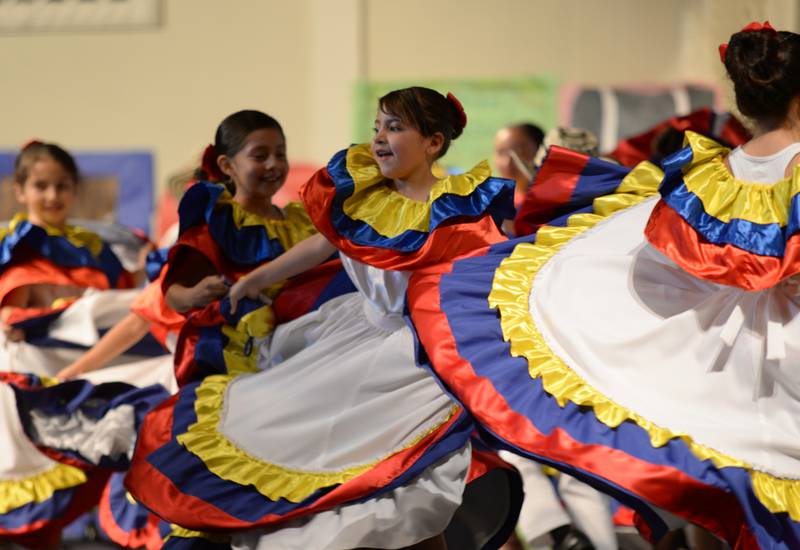 Forest Road students including 2nd grader Eva Hernandez dance to celebrate Columbia cultural while participating in the  Expo De Bellas Artes held at Park Junior High Friday April 21, 2023.