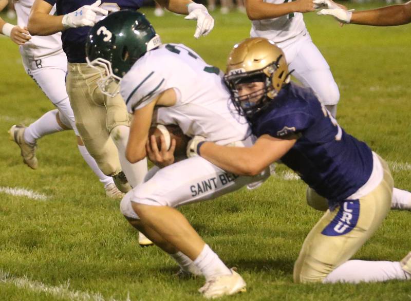 Marquette's Grant Dose brings down St. Bede's Stuart McGunnigal on Friday, Sept. 26, 2025 at Gould Stadium in Ottawa.