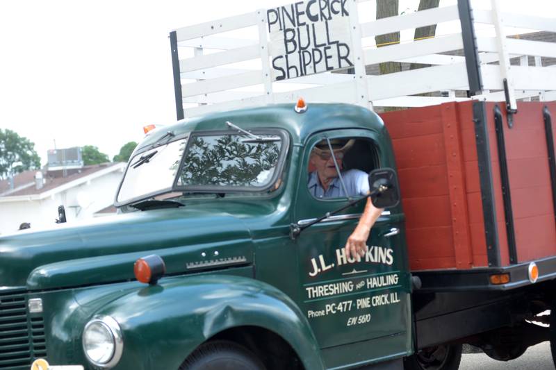 Jim Hopkins of Polo talks to the crowd as he drives his antique farm truck in the Let Freedom Ring parade on July 4.