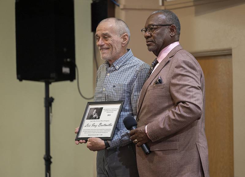 Gordon Harris (right) presents a certificate to Bob Brotmiller in recognition of his mother Lois Brotmiller Sunday, Jan. 19, 2025. Back in the 50’s Lois sold homes to black people in white neighborhoods and was fired from her real estate job. “Lois was a brave woman,” said Harris. Brotmiller was the first of six individuals to be recognized with the Dr. MLK Peace and Justice Award.