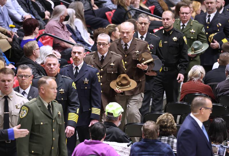 Members of law enforcement file out after going by the casket of fallen colleague DeKalb County Sheriff’s Deputy Christina Musil Thursday, April 4, 2024, during her visitation and funeral in the Convocation Center at Northern Illinois University. Musil, 35, was killed March 28 while on duty after a truck rear-ended her police vehicle in Waterman.