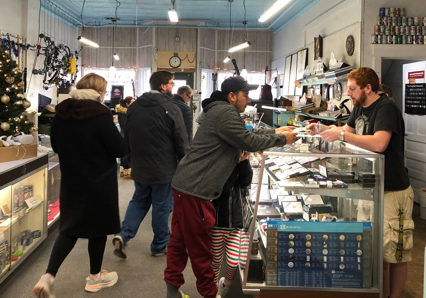 Customers browse and purchase items from Valley Coin and Pawn in Spring Valley on Wednesday, Dec. 28, 2022.