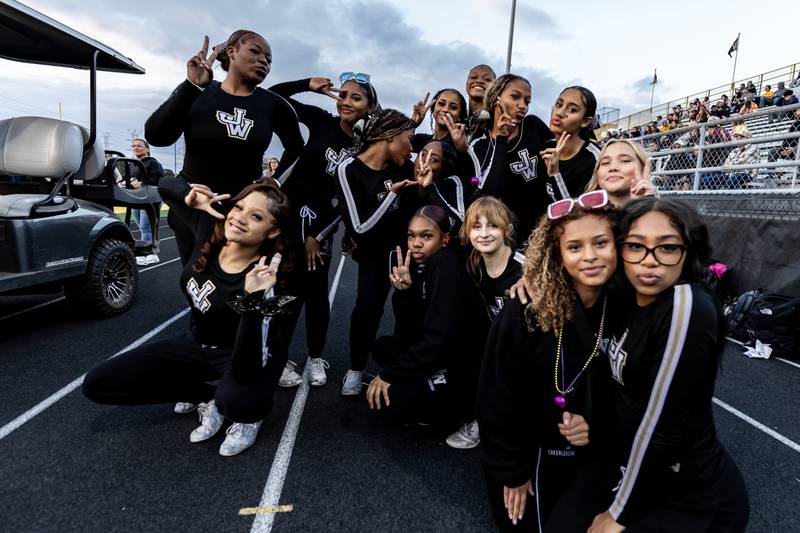Joliet West’s varsity cheer team poses for a photo prior to a varsity football game against Plainfield East at Joliet West on Oct. 10, 2025.