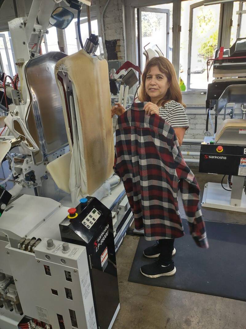 Fernanda Estela, general manager of Production at Zengeler Cleaners, operates one of the new finishing machines at the company’s Park Avenue store in Libertyville. Fernanda has 38 years of experience with Zengeler Cleaners.