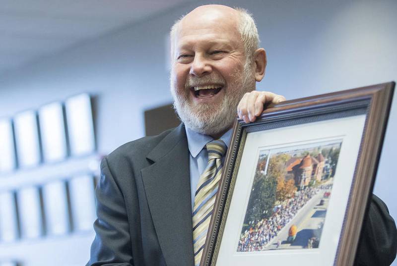 Outgoing Sycamore Mayor Ken Mundy is presented with a framed photo from the Pumpkin Festival during a reception in his honor on Monday, April 17, 2017 in Sycamore.