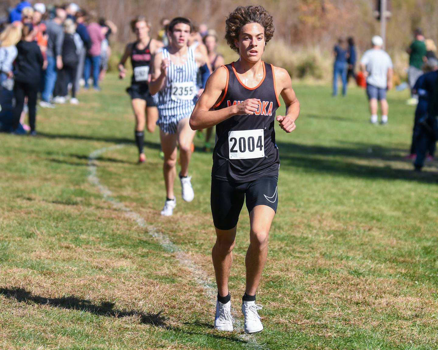 Minooka’s Nico Cimino runs during the conference meet on Friday Oct. 18, 2024, held at Channahon Community Park in Channahon where he took sixth place with a time of 15:05.20.