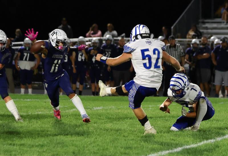 Princeton's Ian Morris boots a 49-yard field goal Friday night at Monmouth. The Titans upset the Tigers 31-3.